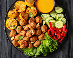 Canvas Print - baked meatballs with vegetables and sauce on plate