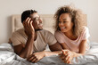 African Young Man Smiling To Attractive Wife Lying In Bed