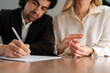 © dikushin - Cropped shot of sad spouses couple signing decree papers getting divorced in lawyers office at desk. Unhappy married man and woman filing divorce, shares or mortgage assets with attorney.