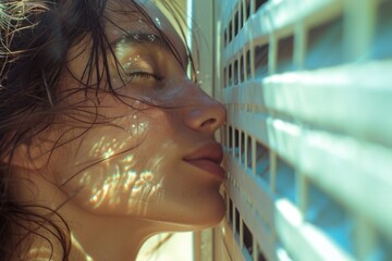 Poster - A woman with her eyes closed looking out of a window. This image can be used to represent contemplation, solitude, or introspection