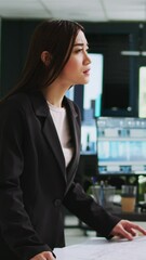 Poster - vertical video asian architect studying blueprint papers in creative agency, examining building mode