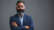 Standing alone on gray with his arms crossed is a proud, self-assured, bearded Indian businessman, investor, wealthy ethnic CEO, corporate executive, professional lawyer, and banker. picture