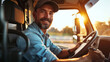 smiling bearded truck driver wearing a cap and a denim shirt is seated in the cab of a truck