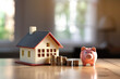 House and pig piggy bank with coins. Real estate and savings. Saving money to maintain property. Municipal budget for the maintenance of buildings. Price cost estimate. Payment of taxes and utilities
