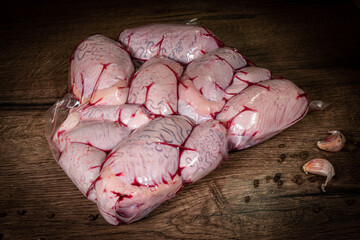 Bull testicles. Raw bull beef testicles balls eggs on wooden background.