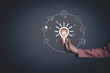 © Atomic62 Studio - Woman hand holding light bulb with online education training. Concept of digital courses to develop new skills, e-learning on internet for personal development, learning, graduation, certificate.