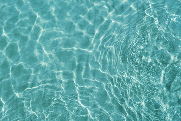 blue water surface viewed from above in outdoor sea, sun reflection, dimply. surface abstract backgr