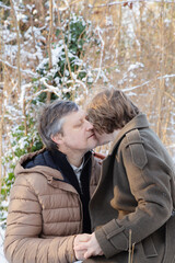 Wall Mural - happy couple in winter snowy park