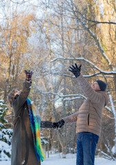 Wall Mural - happy couple in winter snowy park