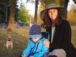 Joyful mother and son portrait in autumn park