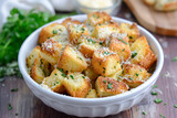 Fototapeta Dinusie - Homemade French croutons, A small dish of toasted seasoned garlic and Parmesan