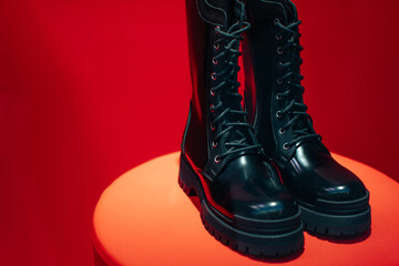 Sticker - Black women's patent leather lace-up shoes on a boutique stand on a red background