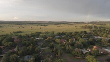 Aerial 4k, Flying Over A Cityscape Of Residential Homes, Moving Towards An Open Field With A Hint Of A Rainbow In The Sky, Centurion, South Africa.
