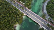 Drone Shot Panning Over The Punta Nizuc Bridge In Cancun Mexico Over The Nichupte Lagoon Surrounded By A Mangrove Forest And Emerald Green River Canal