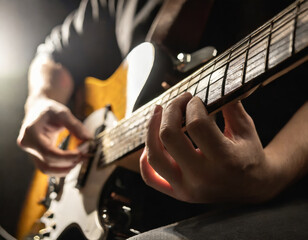 Close-up of a guitarist's hands playing a guitar