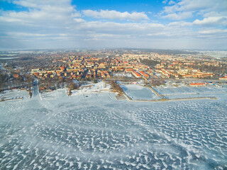 Wall Mural - View of Gizycko town from the Niegocin lake in winter scenery, Mazury, Poland