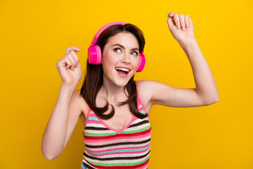 Canvas Print - Photo of lovely girl dressed striped top dancing in headphones look at promo empty space isolated on bright yellow color background