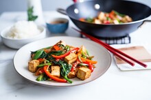 Tofu Stir Fry With Mixed Bell Peppers On Wok