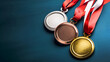 Olympic medals on blue, symbolizing sports achievements. Gold, silver, and bronze medals for Olympic champions. Set of Olympic medals ready for winning athletes