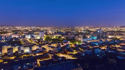 Sticker - Aerial view on Rooftops of Porto's old town on a warm spring evening timelapse day to night transition from above, Porto, Portugal. Lights turning on