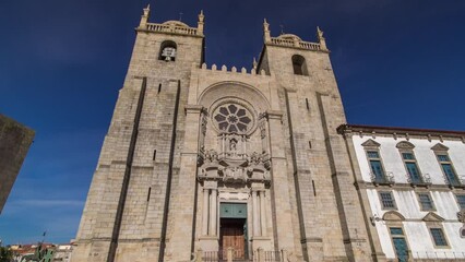 Wall Mural - Porto Cathedral or Se Catedral do Porto timelapse hyperlapse front view with blue sky at sunny day. Romanesque and Gothic architecture.