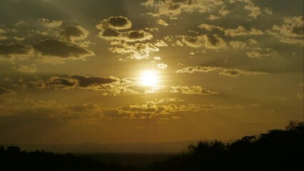 Wall Mural - Sun shining through cumulus clouds, Dramatic sky at sunset, Fluffy clouds at sunset