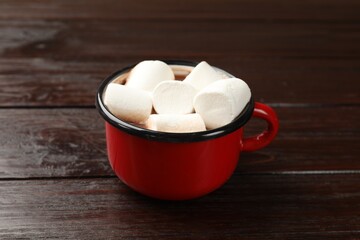 Wall Mural - Tasty hot chocolate with marshmallows on wooden table