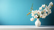 Orchid flowers in vase on blue background