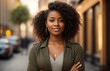 © PeopleWorker - Happy confident positive female entrepreneur standing outdoor on street arms crossed