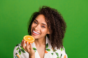 Poster - Photo of funny cheerful woman dressed print shirt smiling enjoying orange half empty space isolated green color background