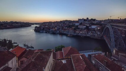 Wall Mural - Panorama of old city Porto at river Duoro, with Port transporting boats at sunset timelapse with the Dom Luiz bridge, Oporto, Portugal