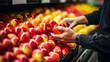 Employees arrange apple fruit on shelves in the store