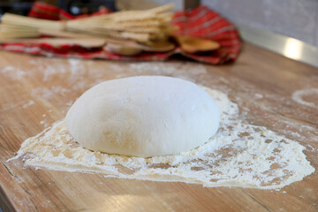 Shaping the sourdough. Shaping a home made bread dough after the first rise. Home made fresh bread making process. Selective focus.