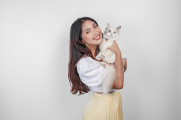 Wall Mural - Portrait of young Asian woman holding cute ragdoll cat with blue eyes. Female hugging her cute long hair kitty isolated by white background. Adorable domestic pet concept.