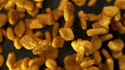 Poster - Super Slow Motion of Flying Fried Chicken Pieces on Black Background. Filmed on High Speed Cinema Camera, 1000fps. Speed Ramp Effect.
