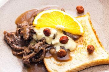 Wall Mural - beef mixture with sauce, hazelnuts and orange served with roasted toast