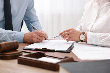 Wall Mural - Lawyers working with documents at table in office, closeup