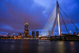 Fototapeta  - Rotterdam, Netherlands - December 26, 2023: Rotterdam Skyline with Erasmus bridge at twilight.