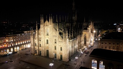 Wall Mural - EUROPE, ITALY, MILAN 01-24-2024 Milan  Cathedral Piazza Duomo by night drone aerial view - sightseeing and tourist attraction in downtown of the fashion city - new skyline 