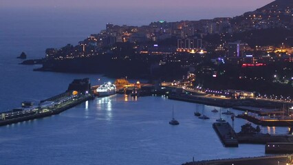 Poster - Island landscape after sunset aerial view to Funchal day to night transition, Madeira, Portugal timelapse. Port in harbor with evening illumination