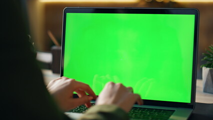 Wall Mural - hands typing greenscreen laptop at office closeup. freelancer working chroma key