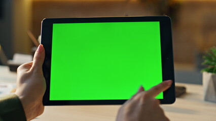 Wall Mural - woman hands swiping mockup tablet at workplace closeup. manager using chroma key