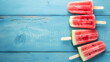 Watermelon slice on a blue wood background.