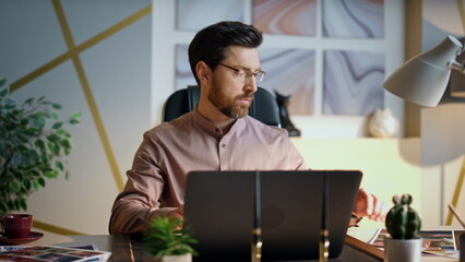Wall Mural - Busy manager working company office with laptop close up. Man looking on papers