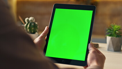 Wall Mural - unknown freelancer looking green screen tablet at desk close up. man holding tab