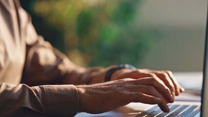 Wall Mural - focused business man typing on laptop office close up. hands pressing buttons.