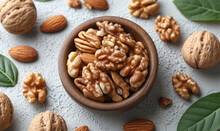 Almonds And Walnuts On White Background. A Wooden Bowl Filled With Assorted Nuts Sits Next To Vibrant Autumn Leaves.