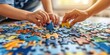 Child hands assembling puzzle pieces on a school desk