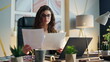 © stockbusters - Young woman entrepreneur analysing papers at office close up. Businesswoman work
