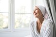 © Anatolii - Cancer woman in white robe smiling and looking out the window